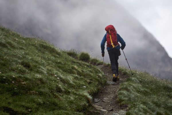hiker walking uphill in mountains
